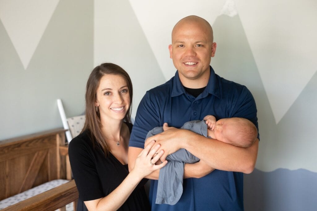 Parents holding newborn son in nursery during their Peyton, CO newborn photography session