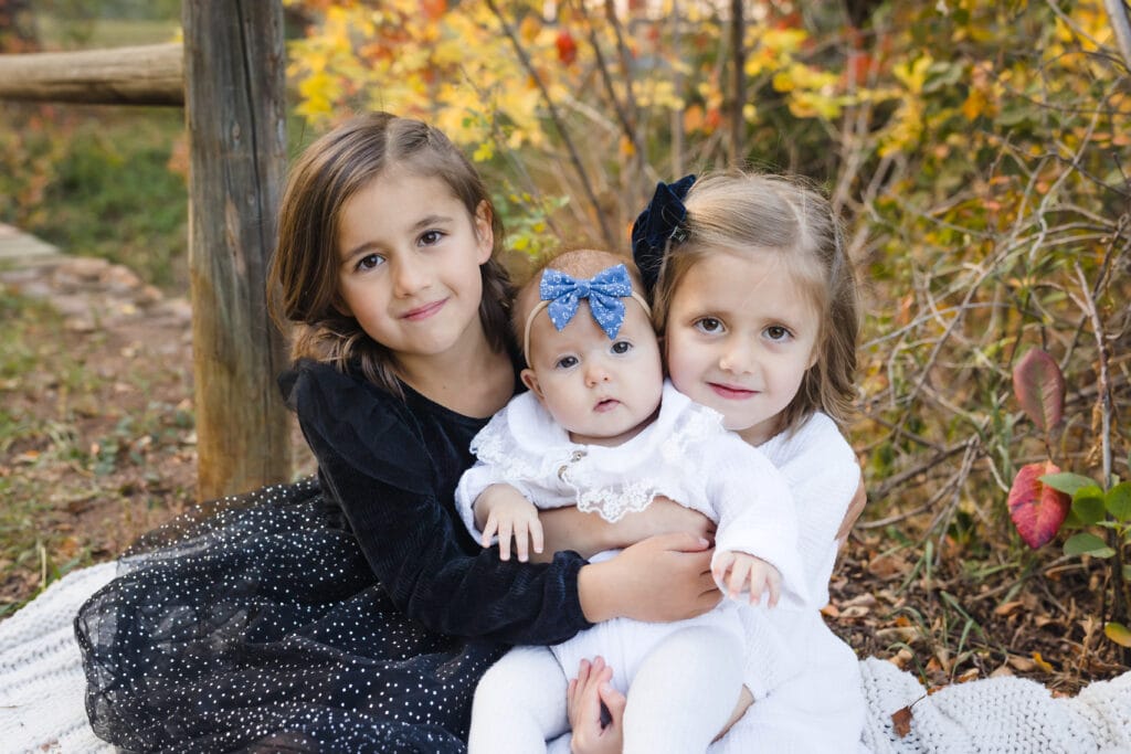 sisters hugging during fall family mini sessions in colorado springs