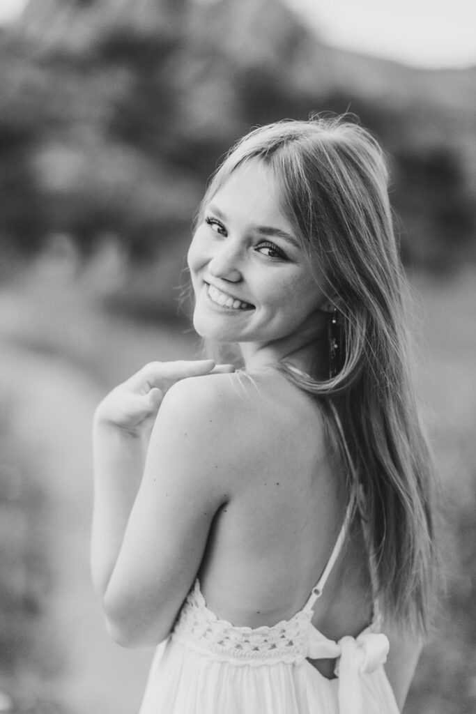 Teenage girl looking over her shoulder and smiling, senior photos Colorado Springs
