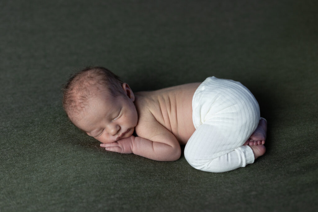 Baby asleep on tummy, 5 questions to ask your newborn photographer