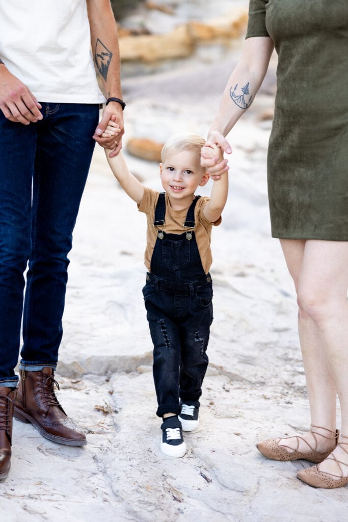 Little boy holding his parents hands, captured by Colorado Springs family photographer Haili Wright Photography