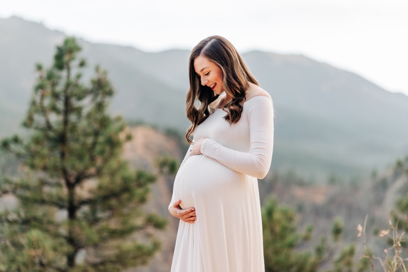 Family Photography, pregnant woman in long white dress holding her belly